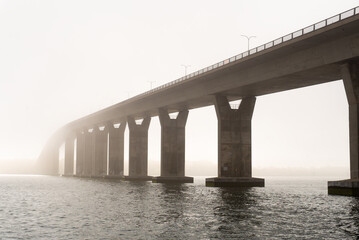 bridge over water in the fog