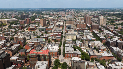 Morning sun shines on beautiful historic building architecture in the heart of the Mount Vernon neighborhood of Baltimore, Maryland, USA.