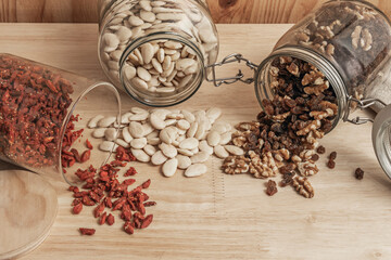 Premium Marcona almonds, Thompson raisins, shelled California walnuts, and goji berries on a beech board