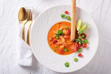 Exquisite Thai soup decorated with peppers, sesame and coriander.