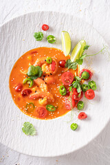 Refined Thai soup with high-end presentation on plate.
