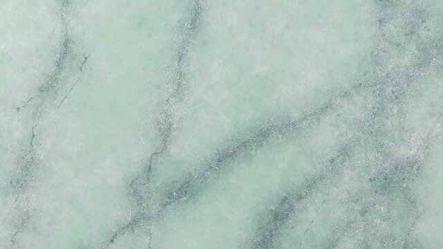 Pale Mint Green Marble with Dark Gray Veins and Speckled Mineral Inclusions texture pale green