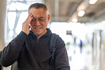 Sick unhappy senior man touching head serious depressed feeling headache thinking of problem,...