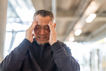 Sick unhappy senior man touching head serious depressed feeling headache thinking of problem,...