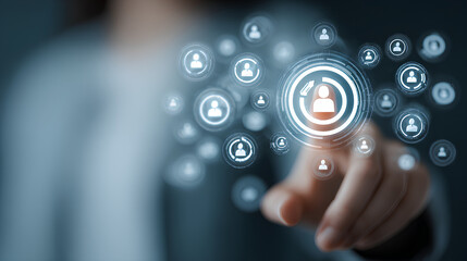 Target Audience and Digital Outreach Strategy Concept. Businessperson points at virtual interface with people icons and marketing symbols, representing audience targeting and global digital strategy.