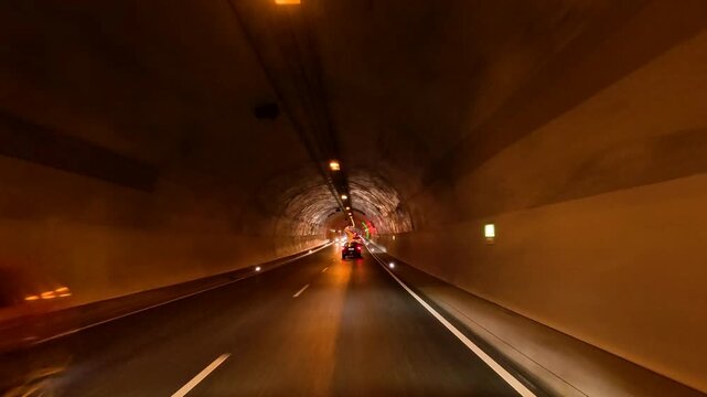 Dresden Germany enter tunnel road traffic POV 2. Driving point of view. Industrial center of East Germany, now unified German, European Union (EU) and NATO. Total destruction in WW II and now rebuilt.