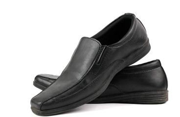pair of elegant and simple black leather loafer shoes for man isolated on a white background