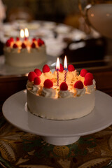 Birthday cake with candles and raspberries
