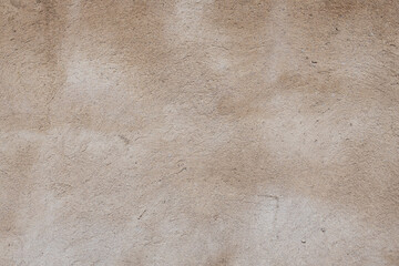 Textured beige wall surface with subtle variations, showcasing natural imperfections and a warm, earthy tone, ideal for backgrounds and design projects emphasizing rustic aesthetics