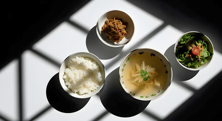 Overhead view of a balanced meal with rice soup salad and meat dish set