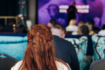Audience at the modern conference hall listens to panel discussion, people on a congress together listen to speaker on stage at convention, plenary session at business seminar, venue for presentation