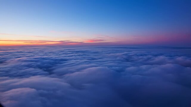 Above the Clouds: The sky transforms into a stunning tapestry of hues, showcasing the sublime artistry of nature, with billowing clouds and the fading glow of a distant sunrise.