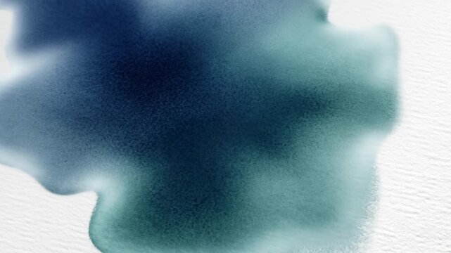 Dark blue watercolor ink spreading on paper