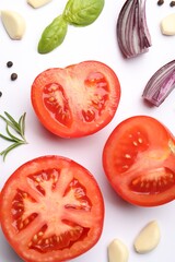 Ripe red tomatoes, spices and herbs on white background, flat lay