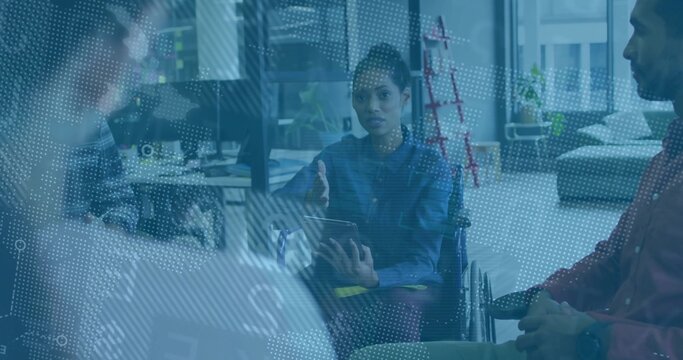 Wheelchair user leading team discussion holding tablet in office lounge, featuring digital overlay