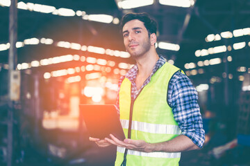 Factory male worker. Engineer man worker working with labtop checking working in industrial manufacturing factory, men at work to checking equipment of machinery production technology or construction.