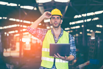 Factory male worker. Engineer man worker working with labtop checking working in industrial manufacturing factory, men at work to checking equipment of machinery production technology or construction.