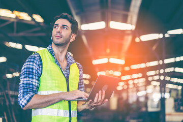 Factory male worker. Engineer man worker working with labtop checking working in industrial manufacturing factory, men at work to checking equipment of machinery production technology or construction.