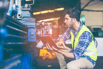 Factory male worker. Engineer man worker working with labtop checking working in industrial manufacturing factory, men at work to checking equipment of machinery production technology or construction.
