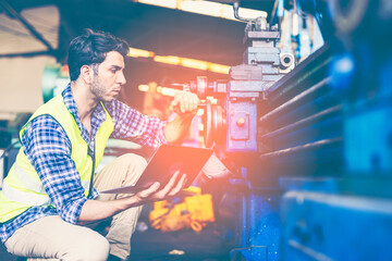 Factory male worker. Engineer man worker working with labtop checking working in industrial manufacturing factory, men at work to checking equipment of machinery production technology or construction.