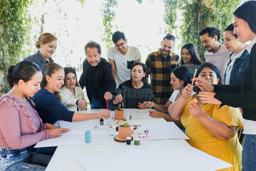 group of latin people in painting classes in a terrace outdoors in Mexico Latin America, multi...