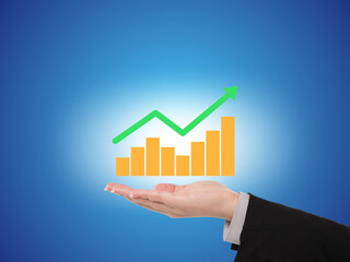 Hand holding a glowing financial growth chart