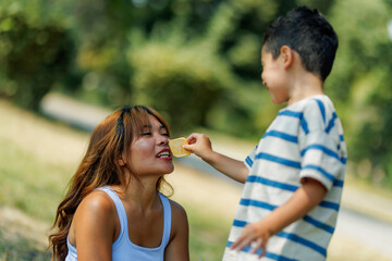 Mother and son enjoy a bonding moment outdoors with playful activities in nature