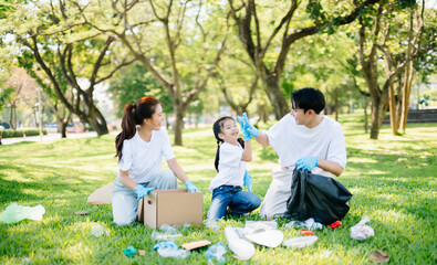 Joyful family volunteering to clean a park together. A heartwarming outdoor scene promoting teamwork, love, and environmental awareness in a green lifestyle.
