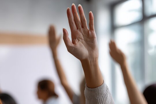 Students raising hands during a class, actively participating and asking questions in a workshop or educational event - Powered by Adobe