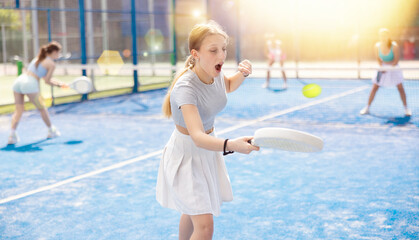 Athletic woman standing on court in summer and playing tennis. Woman against the background of...