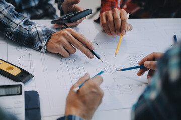 engineer people meeting working and pointing at a drawings in office for discussing. Engineering...