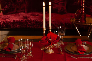 A table set for two in red tones for a banner background