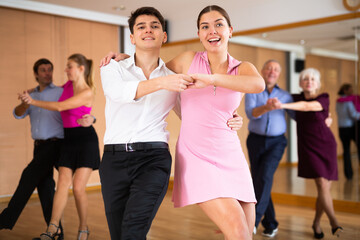 Fototapeta premium at dance lesson for beginners, young couple learn to dance jive