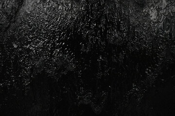 Black background, created by water flowing from the top, black wall as a waterfall.
