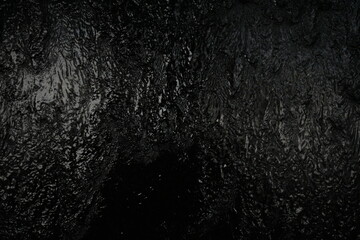 Black background, created by water flowing from the top, black wall as a waterfall.