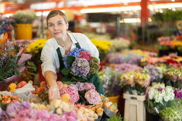 Florist creates bouquet of Phlox in a flower shop