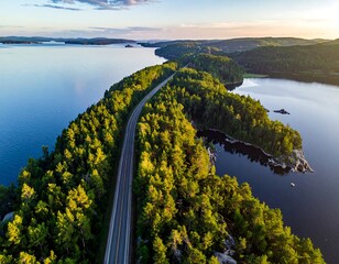 Aerial perspective shows a roadway through a lush, forested island at sunset