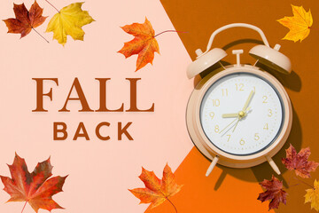 Clock on a brown and pink background with autumn leaves