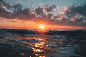 Obraz premium A stunning sunset over a tranquil ocean, with vibrant colors reflecting on the gentle waves, creating a serene atmosphere.