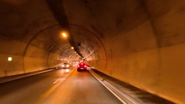 Dresden Germany tunnel entry road traffic POV 2. Driving point of view. Industrial center of East Germany, now unified German, European Union (EU) and NATO. Total destruction in WW II and now rebuilt.