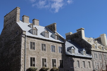 A view in summer of the Old Quebec in Canada with ancient architecture. Panorama of the old Quebec with ancient building. Historic building in Quebec city. Tourism and destination. Rust on the roof.