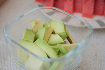 Fresh avocado slices in a glass container for healthy snacks