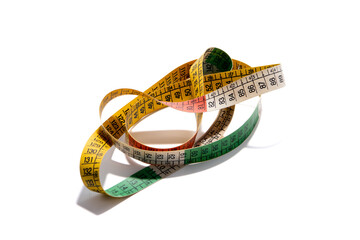 Coiled, colorful tailor's measuring tape, used for sewing, crafting, and body measurements, isolated on a white background. Concept of accuracy, tailor, dressmaking, and precision.
