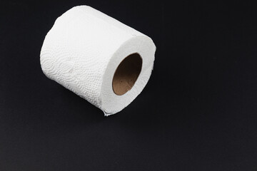 Roll of white paper towels displayed on black background in minimalistic style