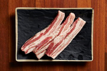 raw pork belly on a plate