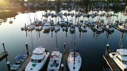 Aerial Sunrise Over Marina – Luxury Yachts and Sailboats in Calm Harbor