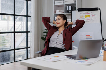 Good Morning. Happy businesswoman working at office and stretching her arms, front view, copyspace, panorama relax woman at work.
