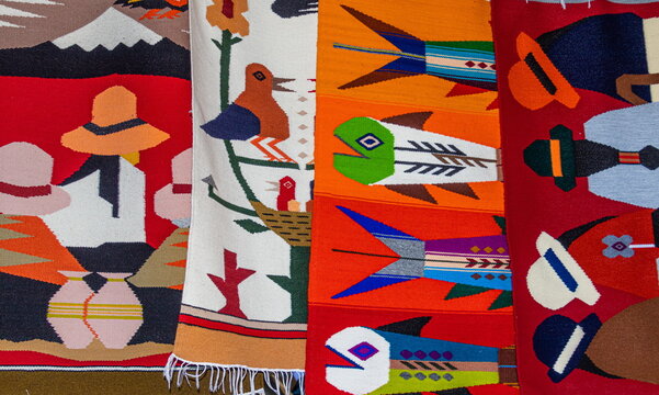 Colorful traditional wool rugs and blankets with Andean designs are sold at the Plaza de los Ponchos artisan market in Otavalo, Imbabura Province, Ecuador	