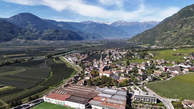 Chiesa Parrocchiale di Santa Maria Assunta in Terlano, small church surrounded by apple orchards. Aerial video.