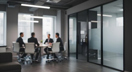 Out-of-focus shot of a professional team collaborating during a strategic planning session in a modern glass-walled boardroom